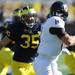 Michigan linebacker Joe Bolden eyes UMass quarterback Mike Wegzyn in the second quarter against UMass at Michigan Stadium on Saturday. Melanie Maxwell I AnnArbor.com